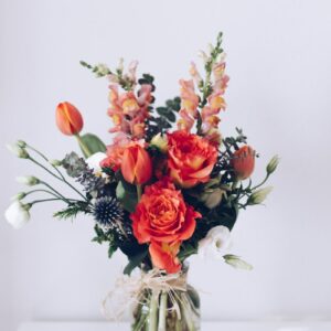 red flower arrangement on white table