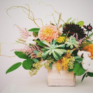 white and pink flowers on brown wooden box