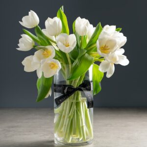 white flowers in clear glass vase