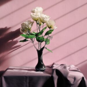 white artificial flowers in black vase